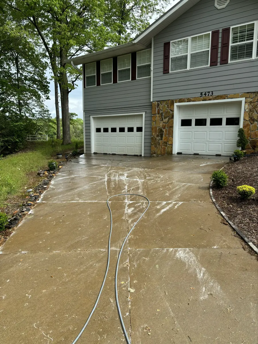 Brown driveway covered in dirt and stains before pressure washing